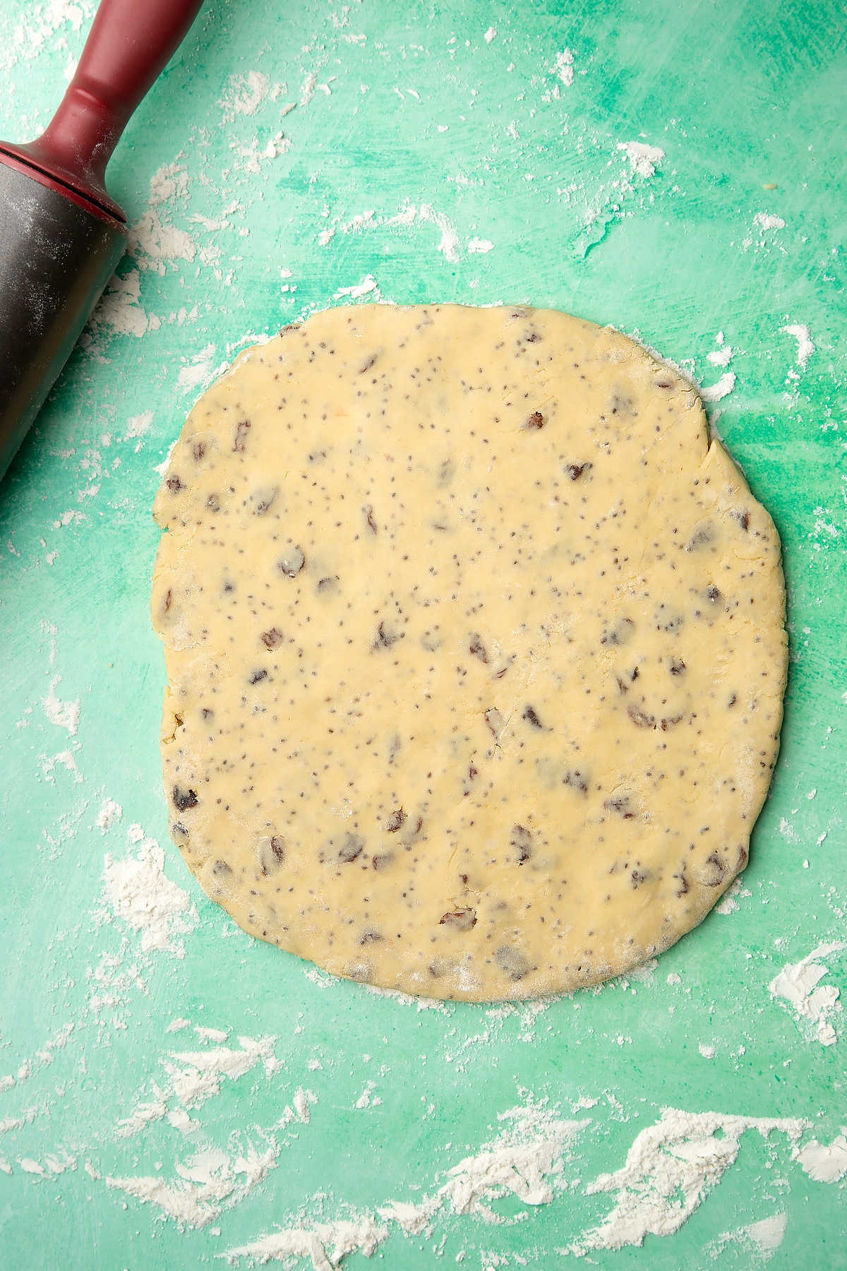 Vegan Welsh cakes dough rolled out on a floured surface. 